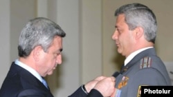 Armenian President Serzh Sarkisian decorates a senior police official on April 16.