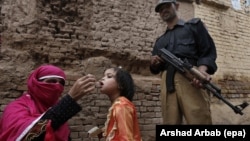 A polio worker administers a polio vaccine to a child in Peshawar. Pakistan is one of a handful of countries where the disease is still endemic.