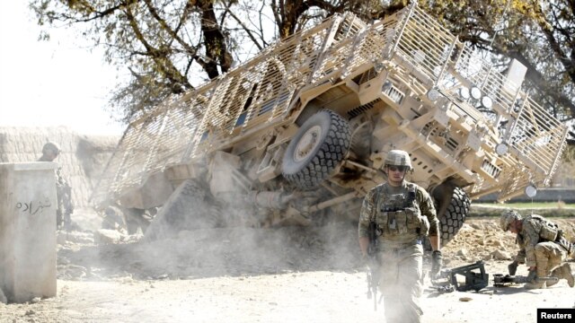U.S. Army soldiers secure the scene after an improvised explosive device exploded during a road-clearance patrol in Logar Province.