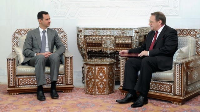 Syrian President Bashar al-Assad (left) meets with Russian Deputy Foreign Minister Mikhail Bogdanov in Damascus in August 2011.