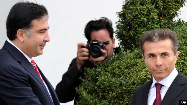 Georgian President Mikheil Saakashvili (left) greets the leader of the Georgian Dream coalition, Bidzina Ivanishvili, in Tbilisi in October.