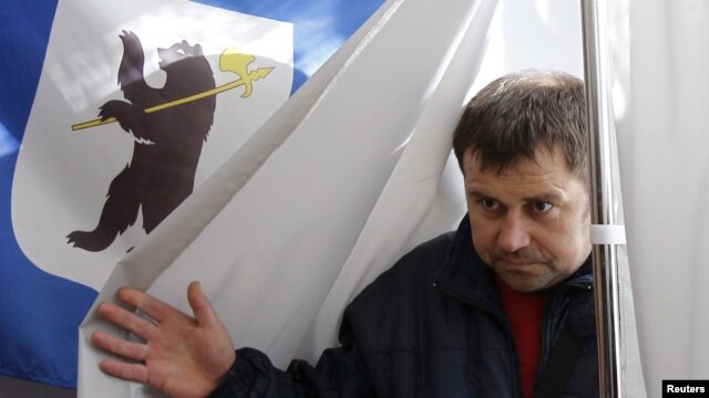 A man leaves a voting booth during the mayoral election in the city of Yaroslavl on April 1.