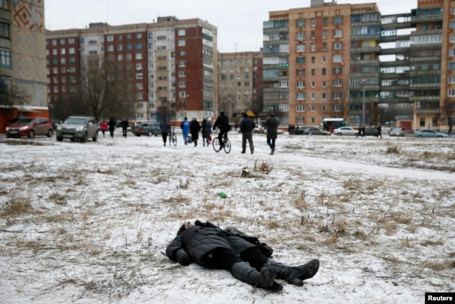 The body of a woman killed by shelling lies in a residential area in the eastern town of Kramatorsk on February 10.