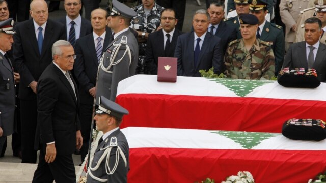 Lebanese President Michel Suleiman pays his respects to intelligence chief Wissam al-Hassan and bodyguard Ahmed Sahyouni at a funeral on October 21 for the slain men, who died in a bomb explosion on October 19.