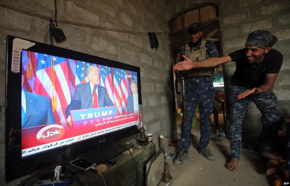 Members of the Iraqi armed forces in the village of Arbid on the southern outskirts of Mosul react as they watch U.S. President-elect Donald Trump giving his victory speech during ongoing military operations to retake Mosul from the Islamic State extremist group. (AFP/Ahmad al-Rubaye)