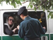 Iran -- A woman sits in a police car after she was arrested because of her 