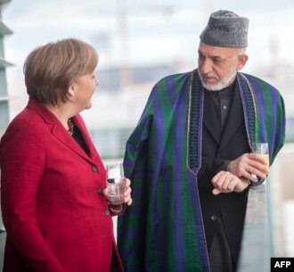 Germany -- Chancellor Angela Merkel (L) talks with Afghan President Hamid Karzai during a meeting at the Chancellery in Berlin, 16May2012