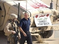 Bush speaks with a U.S. marine as he tours Al-Asad Air Base (AFP)