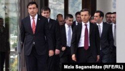Mikheil Saakashvili (left) and Bidzina Ivanishvili stroll toward reporters following their meeting.