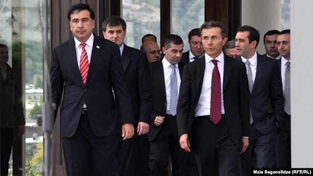 Mikheil Saakashvili (left) and Bidzina Ivanishvili stroll toward reporters following their meeting. 