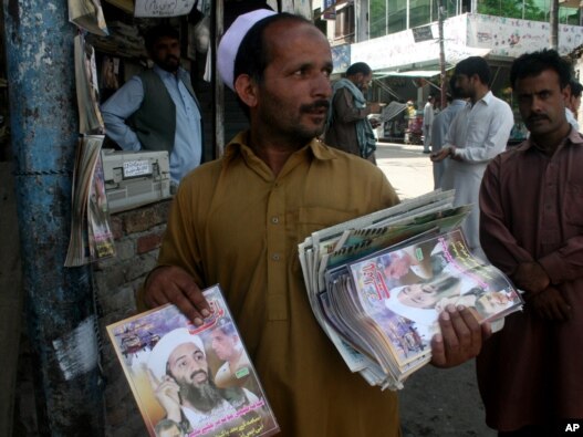 A Pakistani vendor sells local magazines carrying news of Al-Qaeda leader Osama bin Laden's death at the hands of U.S. forces in Abbottabad.