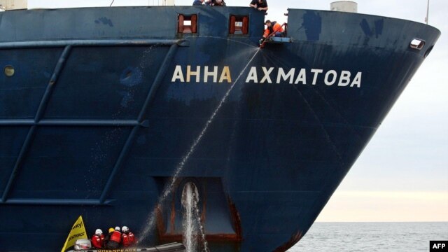 Greenpeace activists attach themselves to the anchor of the Russian passenger ship, "Anna Akhmatova," in the Barents Sea on August 27.