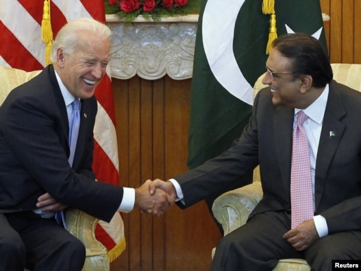 U.S. Vice President Joe Biden (left) shares a laugh while sitting down to meet with Pakistan's President Asif Ali Zardari in Islamabad