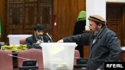 An Afghan lawmaker casts a ballot during the January 2 session that blocked many of Karzai's ministerial choices.