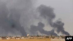 Smoke rises above the Baiji area as Iraqi pro-government forces take part in an operation to retake it from Islamic State militants.