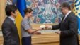 Ukrainian President Petro Poroshenko (right) gives Ukrainian citizenship to Russian public figure Maria Gaidar (center) in Kyiv on August 4.