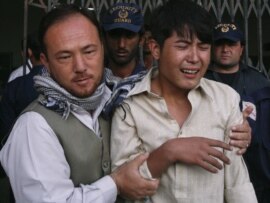 A relative of one of the shooting victims is comforted at the local hospital in Quetta.