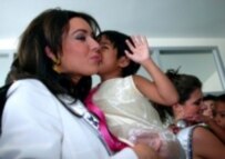 Natalie Glebova with an orphan baby at a children's home in Thailand