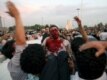 Demonstrators carry a seriously wounded man out of the fray.