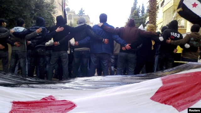 Antigovernment demonstrators protest in the city of Homs on January 9.