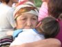 Kazakhstan – Kazakh elderly woman with child protests together with other Shanyraq village residents blocking the main road, Almaty, 23Jul2009
