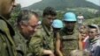 Optuženi za ratne zločine i genocid Ratko Mladić razgovara sa dječakom Izudinom Alićem u Potočarima , jula 1995