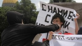 A man attacks an activist during a gay-pride parade in St. Petersburg last year, typical of the violence marchers face.