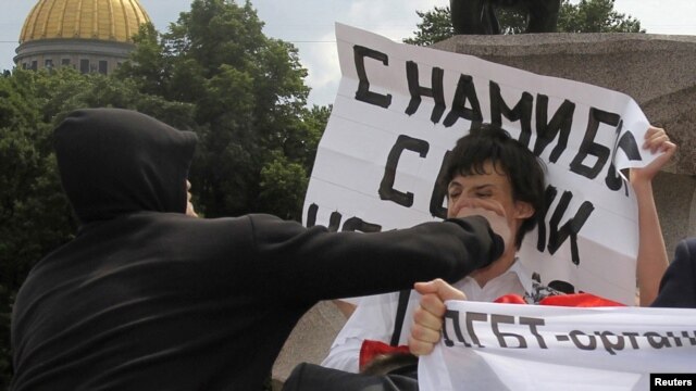 A man attacks a gay rights activist during an unsanctioned gay pride parade in St. Petersburg in June.