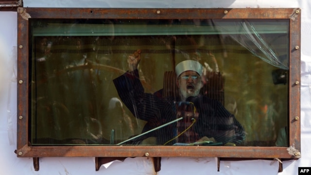 Islamic cleric Muhammad Tahir-ul-Qadri addresses his audience behind bulletproof glass at a rally in Islamabad on January 16.
