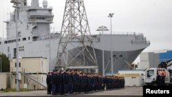 Russian sailors gather in front of the Mistral-class helicopter carrier "Vladivostok" at the STX Les Chantiers de l'Atlantique shipyard site in Saint-Nazaire on December 17.
