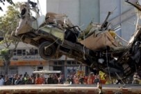 The remains of the bus being removed from the scene (AFP)