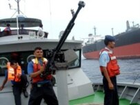 Yemeni coast guards keep watch next to the damaged Japanese tanker Takayama, attacked by heavily armed pirates off the coast of Somalia (AFP)