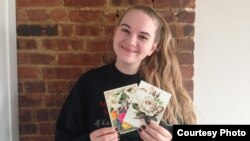 "No matter what's going on with politics, people do not change," says 22-year-old Vera Golikova, holding some of her postcards. "People really want to be good to each other."