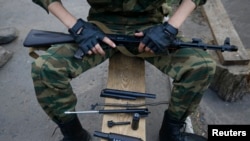 A pro-Russian fighter lays out parts from some of his weapons in eastern Ukraine on May 23.