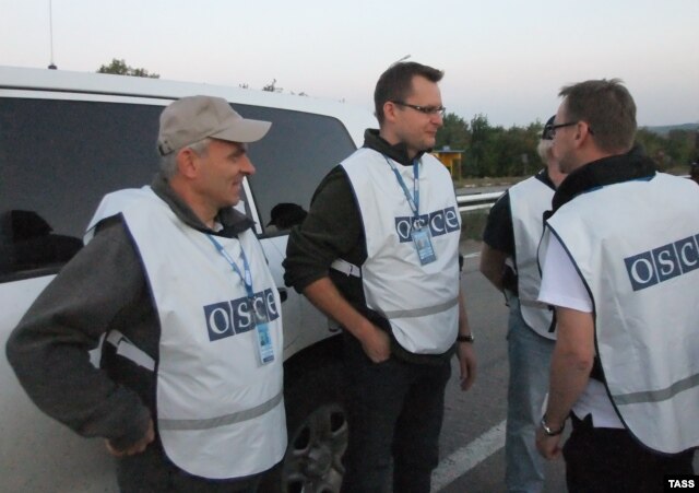 OSCE observers oversee an exchange of prisoners between the Ukrainian Army and pro-Russian rebels in Donetsk in late September.