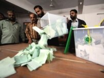 Electoral officials empty a ballot box in Karachi in Pakistan's general election on February 18 (AFP)