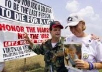 Cindy Sheehan (R) of Gold Star Families for Peace walks with war veteran Dennis Kyne near the president's ranch