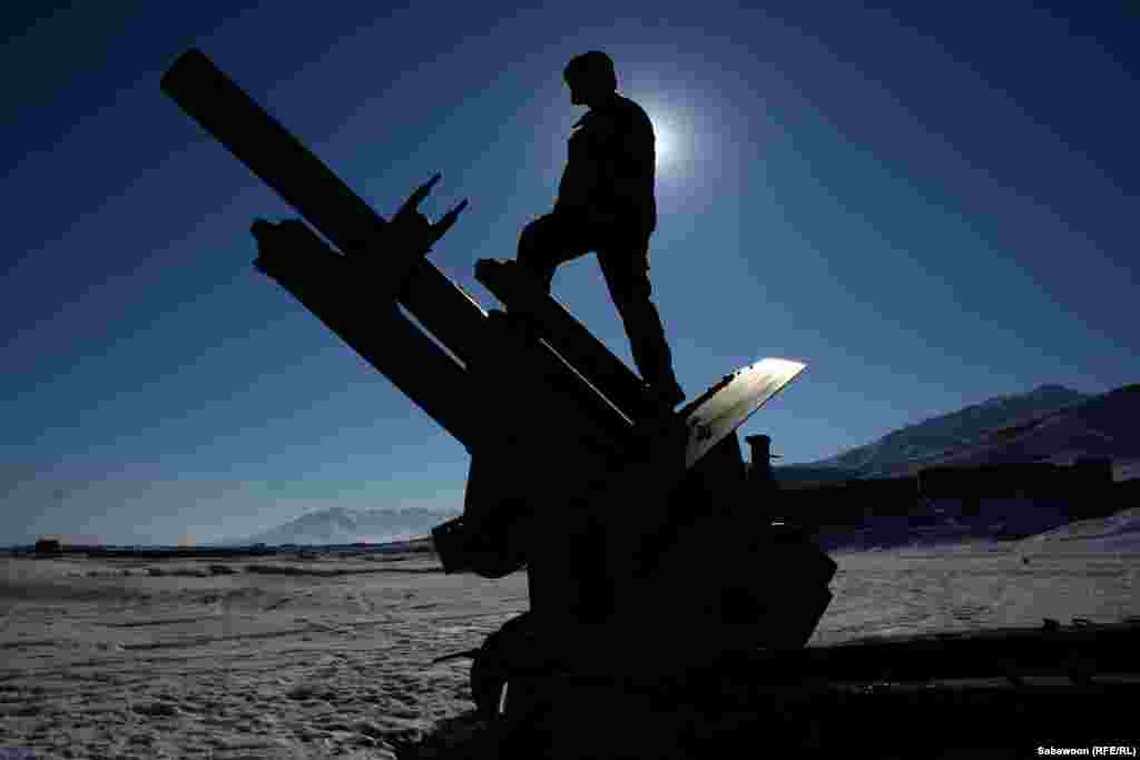 WINNER: A boy plays with abandoned Russian weaponry on the outskirts of Kabul. (Sabawoon, Kabul bureau of RFE/RL's Radio Free Afghanistan)