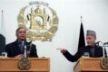 Afghan President Hamid Karzai gestures toward visiting Pakistani Prime Minister Shaukat Aziz in January 2007