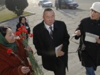 Kyrgyz activists attempt to present flowers to a lawmaker in Bishkek on March 7 (photo courtesy of Eric Gourlan/Agency of Social Technologies)