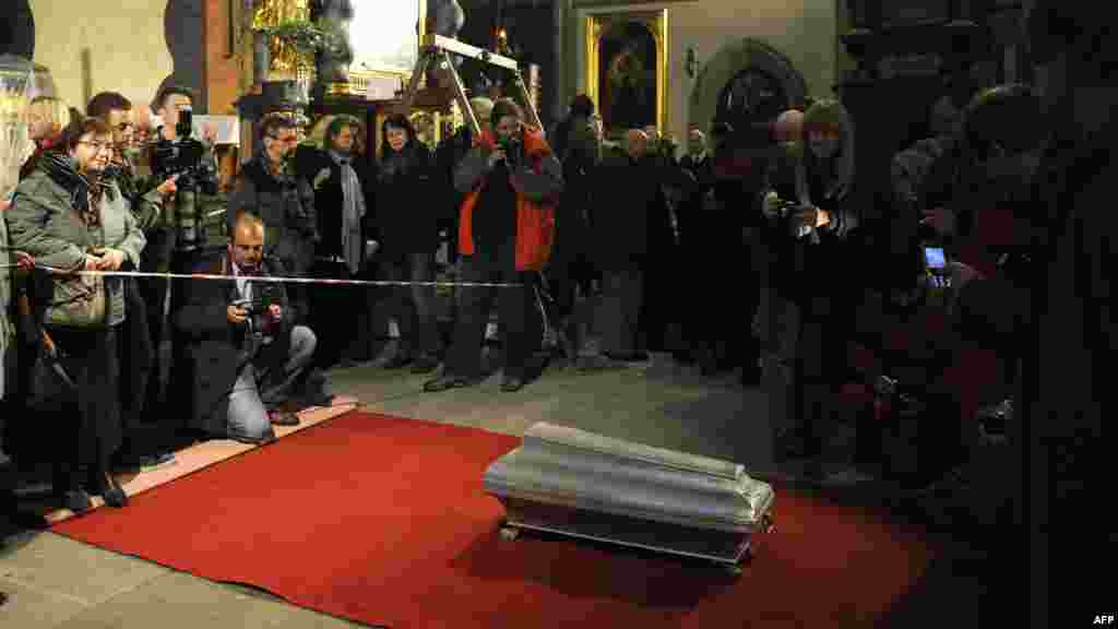 The coffin of 16th-century Danish astronomer Tycho Brahe lies on a red carpet after archaeologists lifted it from his grave at the Church of Our Lady in Prague. Brahe died suddenly in 1601 at the age of 54 of what was believed to be a bladder infection. But some speculated that he may have been poisoned with mercury, possibly at the hands of a king or a rival astronomer. Danish scientists took samples from Brahe's body. They said on November 15 that "mercury concentrations were not sufficiently high" to cause the death. Brahe is credited with celestial observations which helped lay the groundwork for modern astronomy. (AFP/Michal Cizek)
