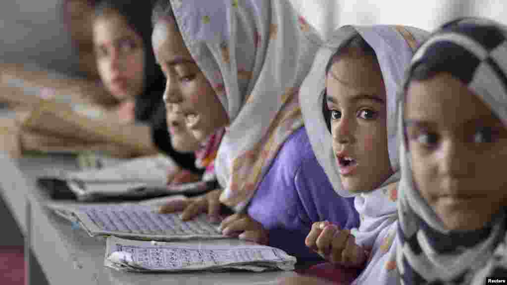 Girls recite verses from the Koran at a madrasah in Islamabad on July 27. (REUTERS/Rebecca Conway)