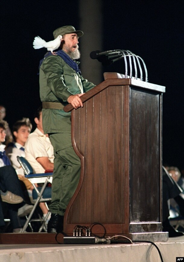 A dove rests on Castro's shoulders as he addresses Cuban youth in 1989 during celebrations marking the 30th anniversary of the country's communist revolution. 