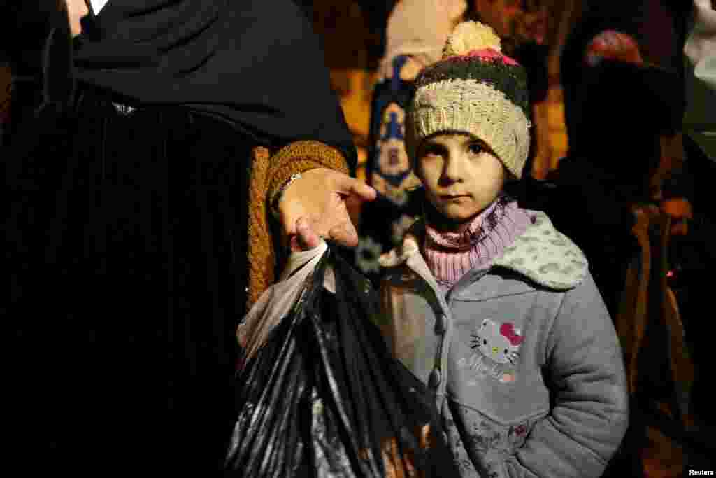 A Syrian girl waits with her family, who say they have received permission from the Syrian government to leave the besieged town, after an aid convoy finally entered Madaya, Syria, on January 11. Thousands have been trapped without supplies for months and people are reported to have died of starvation. (Reuters/Omar Sanadiki)