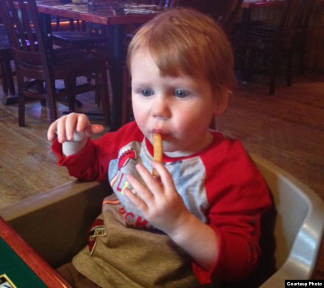 Preston Summers, who is nearly 2 years old, enjoys his first french fry at home in the United States.