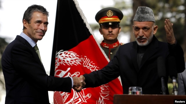 Afghan President Hamid Karzai (right) welcomed NATO Secretary-General Anders Fogh Rasmussen to Kabul on October 18.