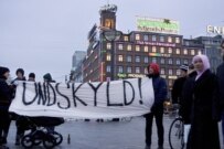 Young people with a banner reading \