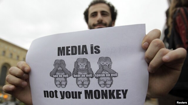 A man holds a banner during a rally to mark World Press Freedom Day in Tbilisi on May 3.