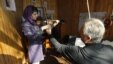 Afghanistan -- A teacher adjusts the finger placement of a student playing a violin at the Kabul Music Academy, 07Jan2012