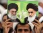 Iranian cleric holding a portrait of Khamenei (L) and the late founder of the Islamic republic Ayatollah Ruhollah Khomeini, during a speech by the supreme leader in Tehran, 13Dec2009